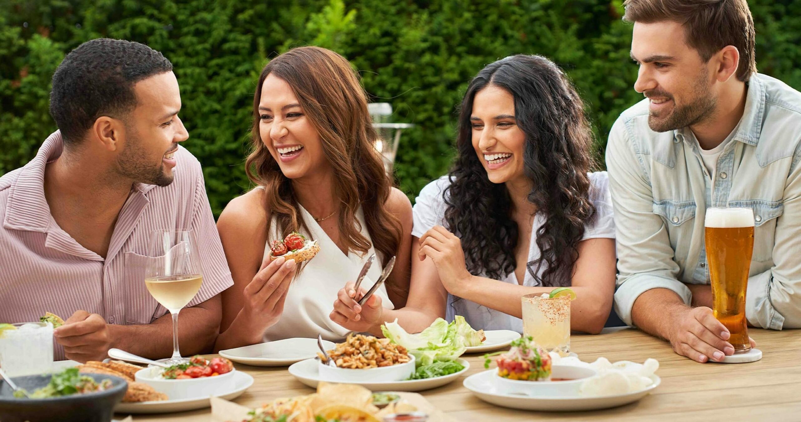 Four people enjoying food at Moxies